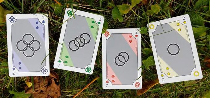 The four Ring cards photographed on grass, showing their colored corners