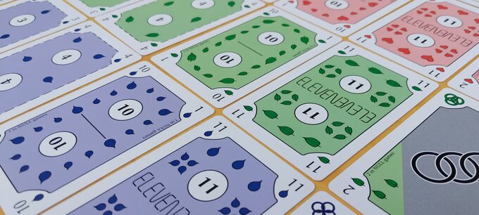 Blue Rings cards scattered on grass, showing the blue, green, and red suits